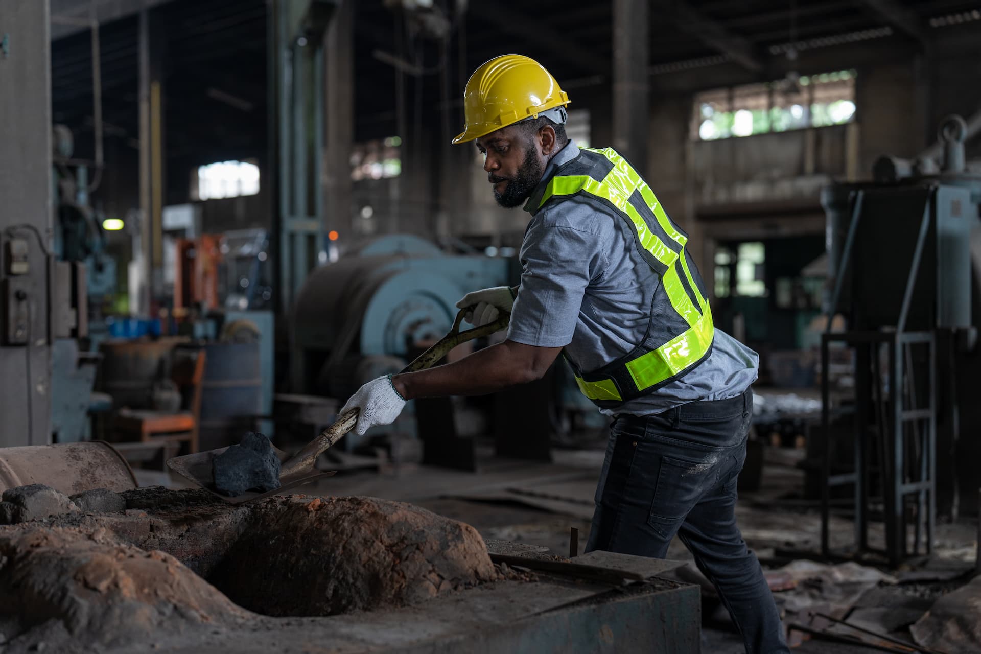 african-american-male-worker-using-shovel-to-scoop-2023-11-27-05-20-31-utc (1)