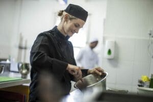 Female chef preparing food in a restaurant kitchen