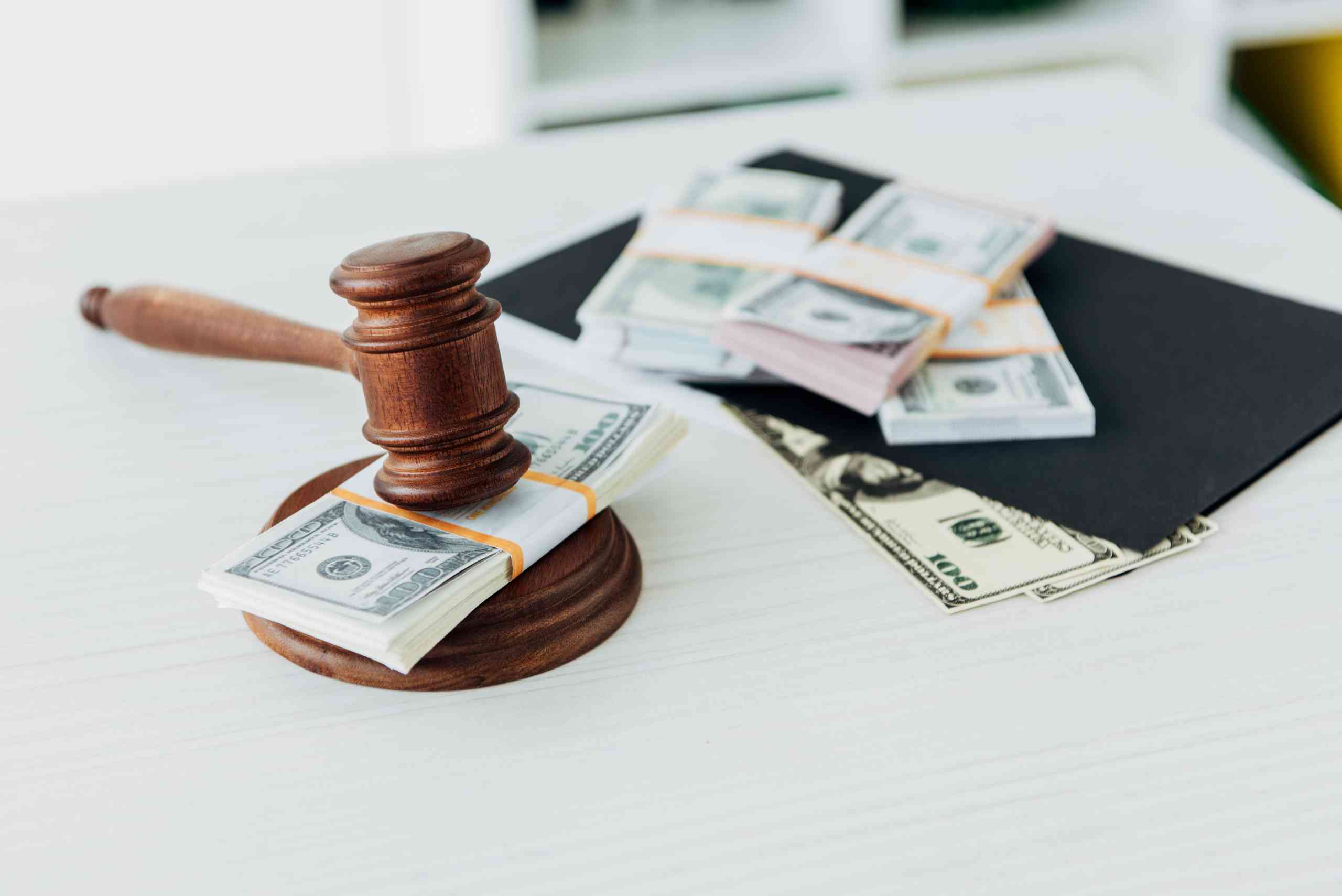 selective focus of gavel of judge near dollar banknotes on table Gavel with cash on a desk top